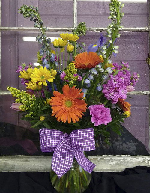 “Color Me Happy”<br />
This bouquet features colorful fresh spring flowers in a vase. $65