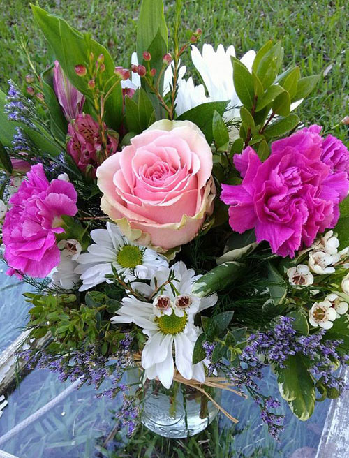 “Hugs & Roses”<br />
A lovely arrangement in a mason jar to bring in that country fresh feeling of love into your  life. $45 and up.