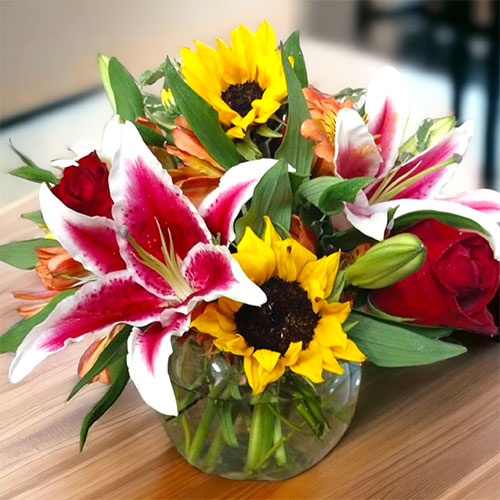 “Rays of Sunshine” Sunflowers, stargazers and roses light up the room in this amazing bouquet. $50.